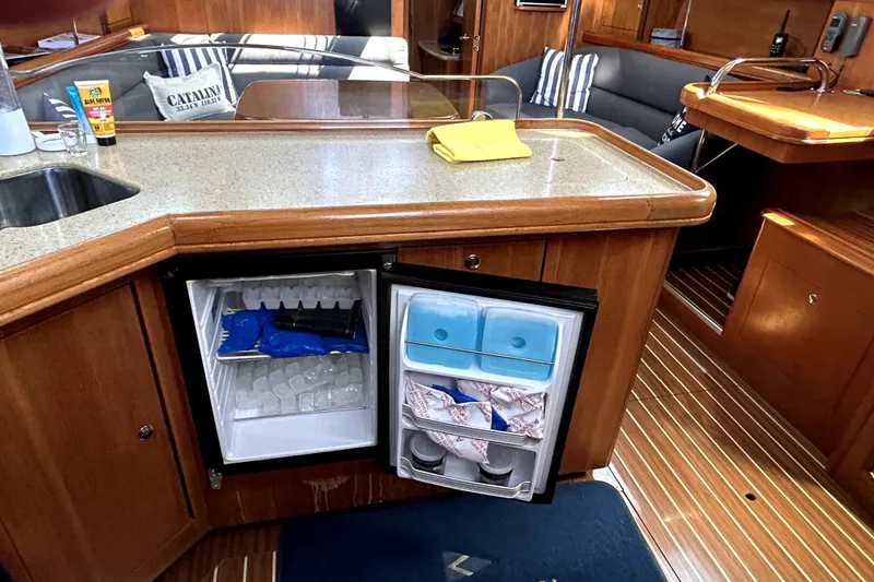 Slide: The Image of 2007 Hunter 41 Deck Salon kitchen with stove, microwave, and sink. - 7