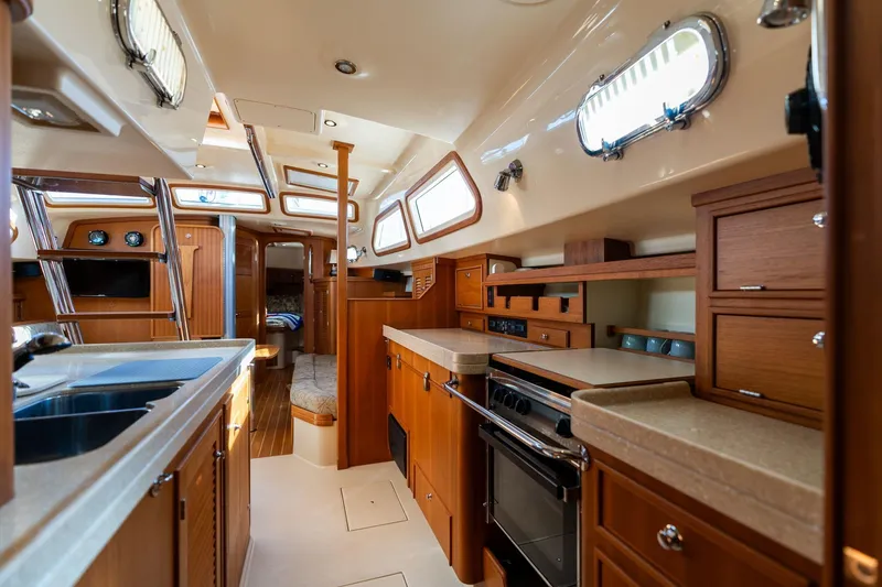 Slide: The Image of Luxurious interior of 2008 Island Packet 465 yacht with modern kitchen and wood finishes. - 13