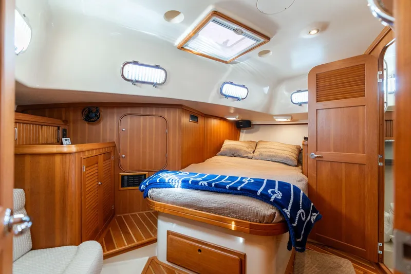 Slide: The Image of Luxurious 2008 Island Packet 465 yacht cabin with cozy bed and elegant wood finish. - 15