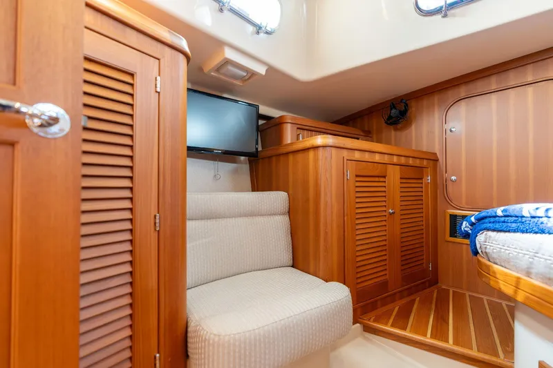 Slide: The Image of Interior of 2008 Island Packet 465 yacht with wooden cabinetry and seating area. - 16