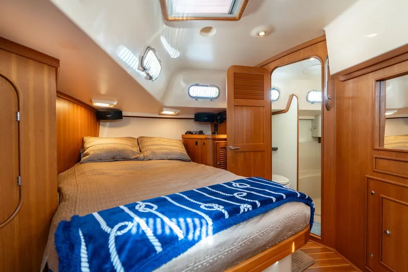 Slide: The Image of Luxurious cabin interior of 2008 Island Packet 465 yacht with cozy bed and wooden finish. - 18