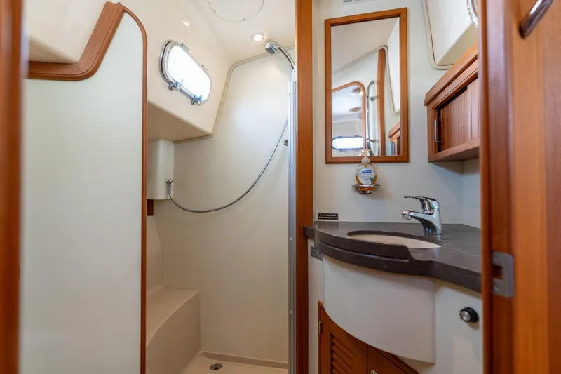 Slide: The Image of Luxurious bathroom in 2008 Island Packet 465 yacht with modern fixtures and wood accents. - 19