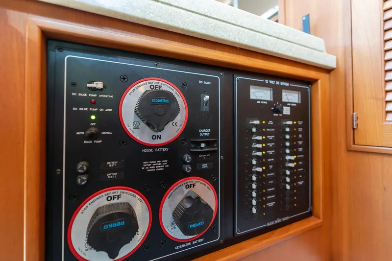 Slide: The Image of Electrical control panel on a 2008 Island Packet 465 yacht, featuring battery and system switches. - 27