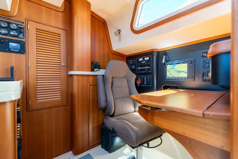 Slide: The Image of Interior of 2008 Island Packet 465 yacht with navigation station and control panel. - 29