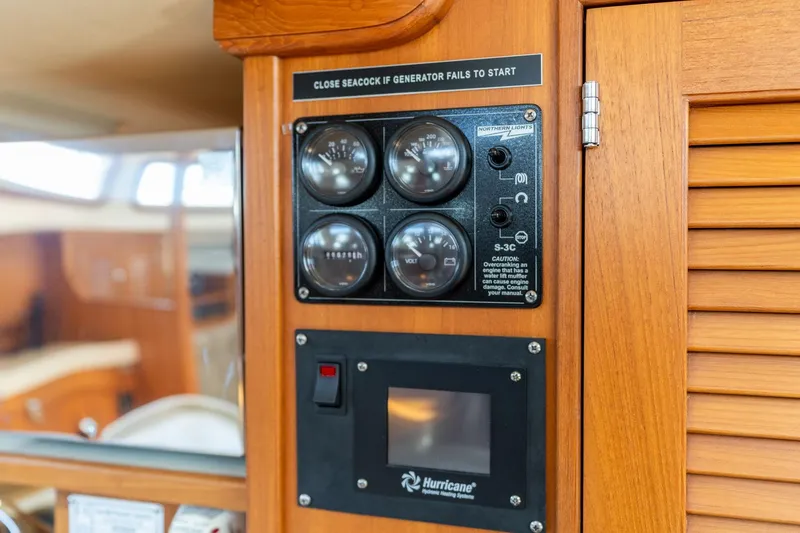Slide: The Image of Control panel on 2008 Island Packet 465 yacht, featuring gauges and warning labels. - 30