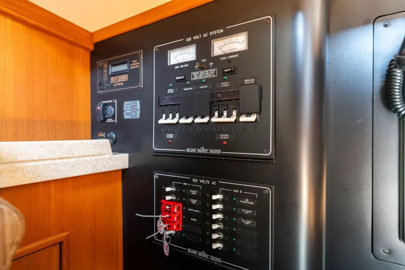 Slide: The Image of Electrical panel of a 2008 Island Packet 465 yacht, featuring control switches and meters. - 31