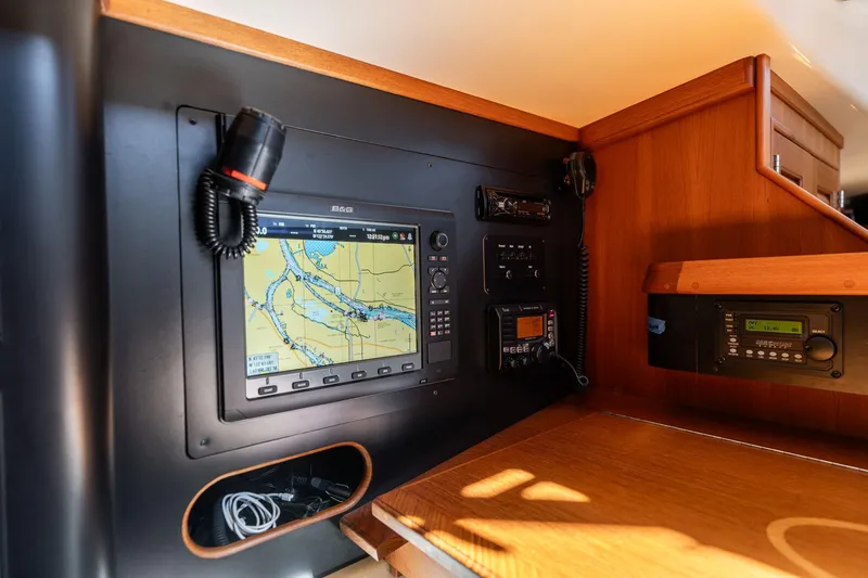 Slide: The Image of Navigation equipment on 2008 Island Packet 465 yacht, featuring a B&G chartplotter and communication devices. - 32
