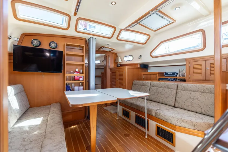 Slide: The Image of Luxurious 2008 Island Packet 465 yacht interior with seating, table, and entertainment system. - 34
