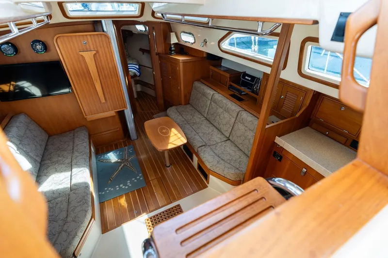 Slide: The Image of Interior of 2008 Island Packet 465 yacht with cozy seating and wooden finishes. - 4