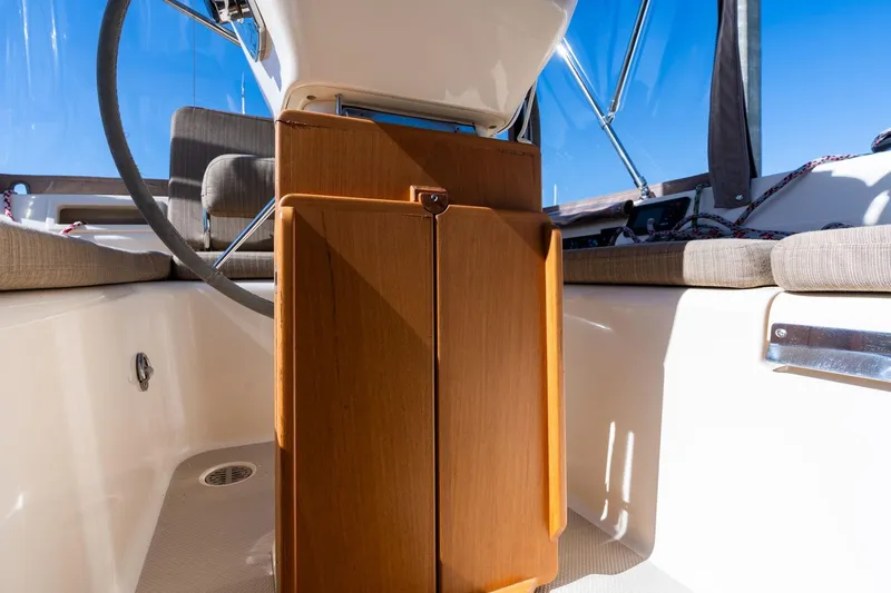 Slide: The Image of 2008 Island Packet 465 yacht cockpit with wooden cabinetry and steering wheel. - 41