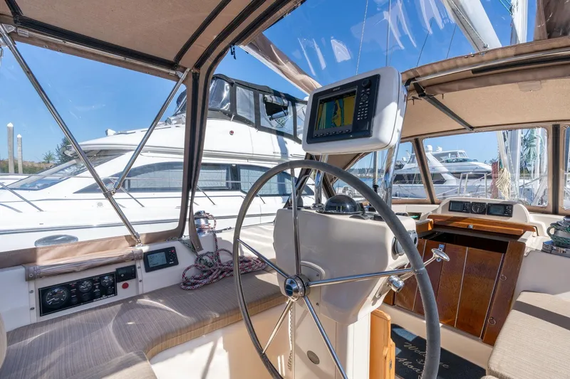 Slide: The Image of 2008 Island Packet 465 yacht cockpit with steering wheel and navigation equipment. - 44