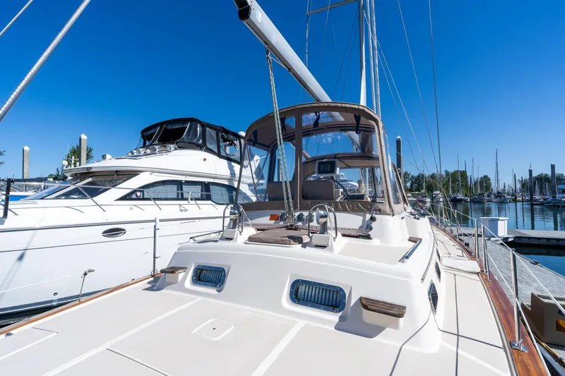 Slide: The Image of 2008 Island Packet 465 yacht docked at marina under clear blue sky. - 55