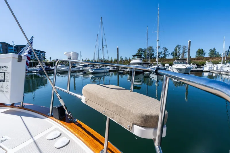 Slide: The Image of 2008 Island Packet 465 sailboat docked in a serene marina under clear blue skies. - 56