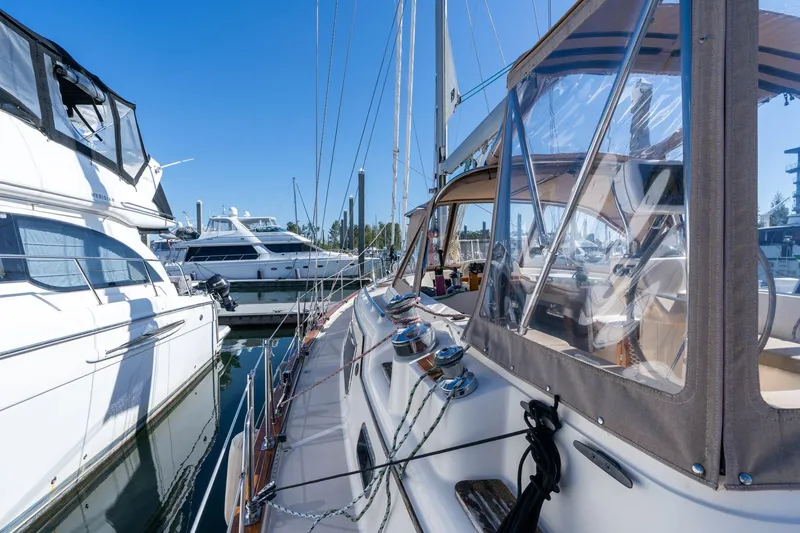 Slide: The Image of 2008 Island Packet 465 yacht docked at marina, clear blue sky, luxury sailing vessel. - 58