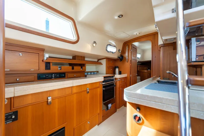Slide: The Image of Luxurious 2008 Island Packet 465 yacht interior with modern kitchen and wooden cabinetry. - 6