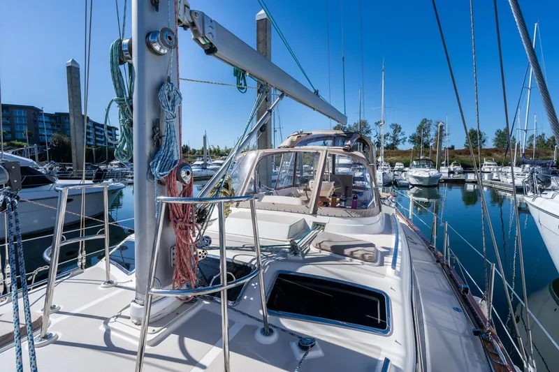 Slide: The Image of 2008 Island Packet 465 sailboat docked in a marina under clear blue skies. - 61