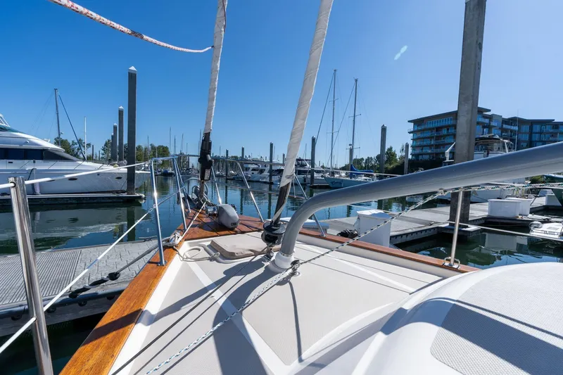 Slide: The Image of 2008 Island Packet 465 sailboat docked at marina under clear blue sky. - 64