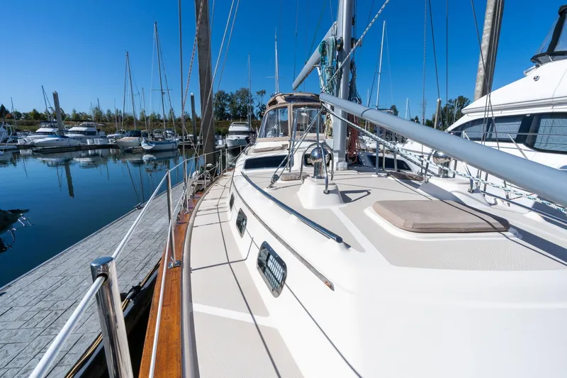 Slide: The Image of 2008 Island Packet 465 sailboat docked in a marina under clear blue skies. - 67