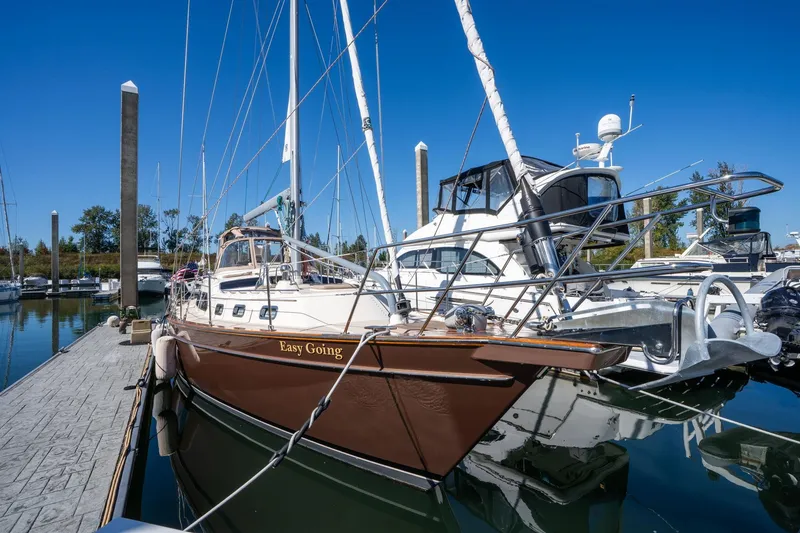 Slide: The Image of 2008 Island Packet 465 sailboat docked at marina under clear blue sky. - 68