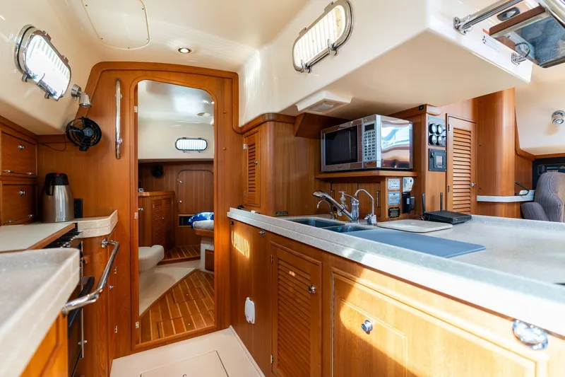 Slide: The Image of Luxurious 2008 Island Packet 465 yacht interior with modern kitchen and cozy cabin. - 7