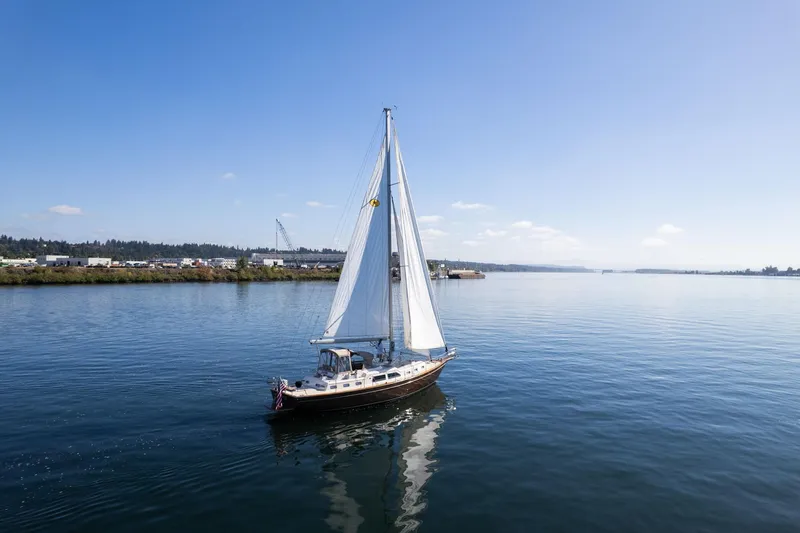 Slide: The Image of Sailing yacht Island Packet 465 (2008) on calm waters under clear blue sky. - 77