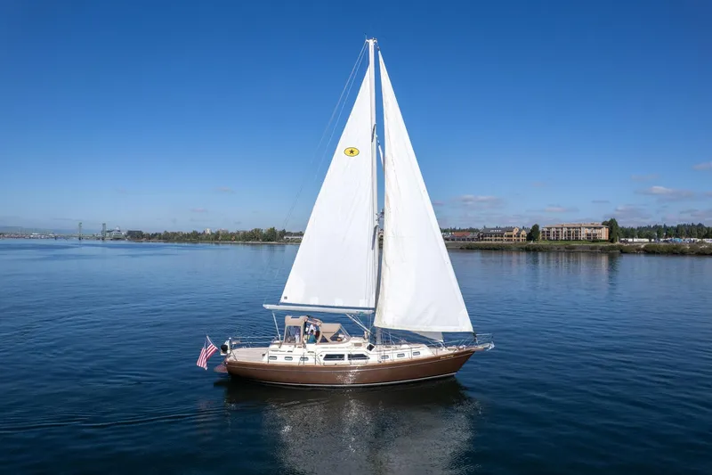 Slide: The Image of 2008 Island Packet 465 sailboat cruising on calm waters under clear blue skies. - 78