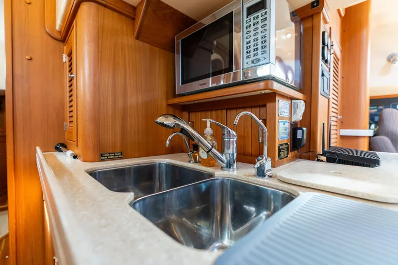 Slide: The Image of Luxurious 2008 Island Packet 465 yacht kitchen with stainless steel sink and microwave. - 8