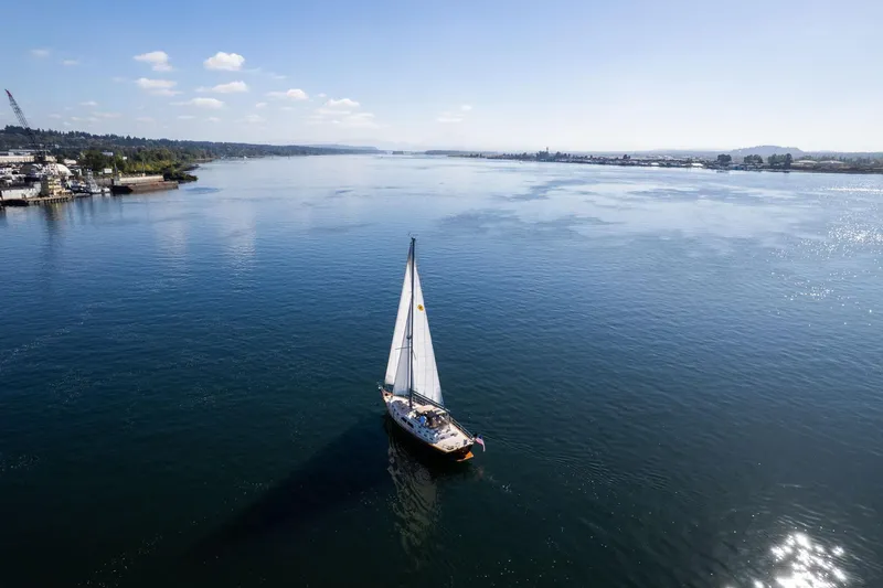 Slide: The Image of Sailboat Island Packet 465 (2008) cruising on a calm, scenic river under a clear blue sky. - 80