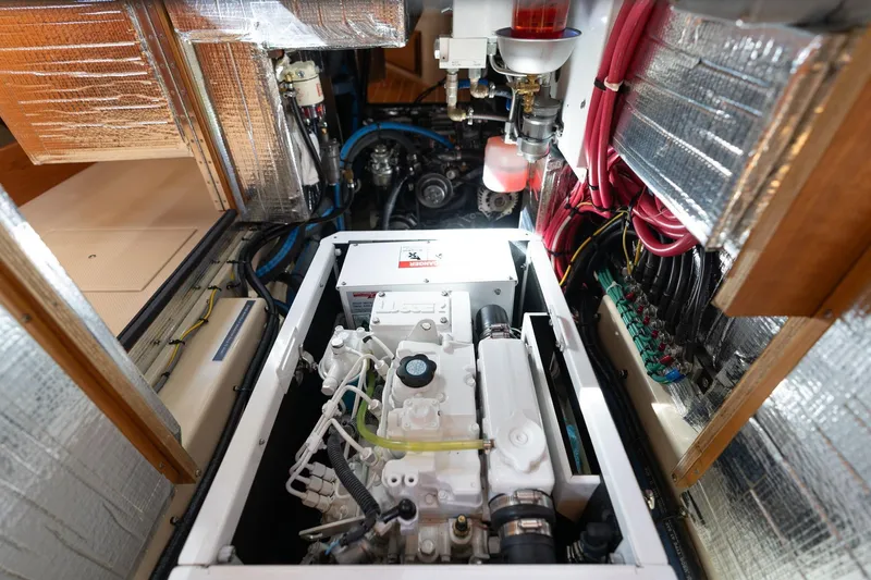 Slide: The Image of Engine room of 2008 Island Packet 465 yacht, showcasing mechanical components and wiring. - 84