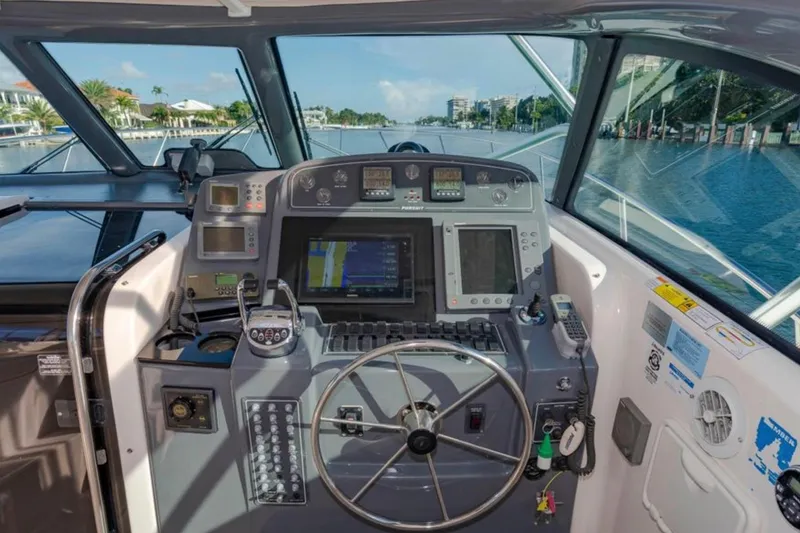 Slide: The Image of Cockpit of 2004 Pursuit 3800 Express boat with navigation equipment and steering wheel. - 8