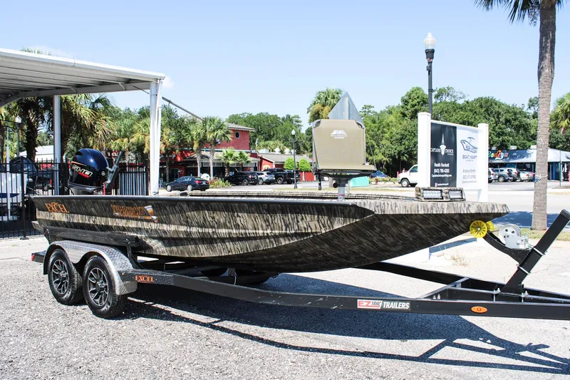 Slide: The Image of 2026 Excel Tomahawk 183 boat with Yamaha engine on trailer, parked outdoors. - 1