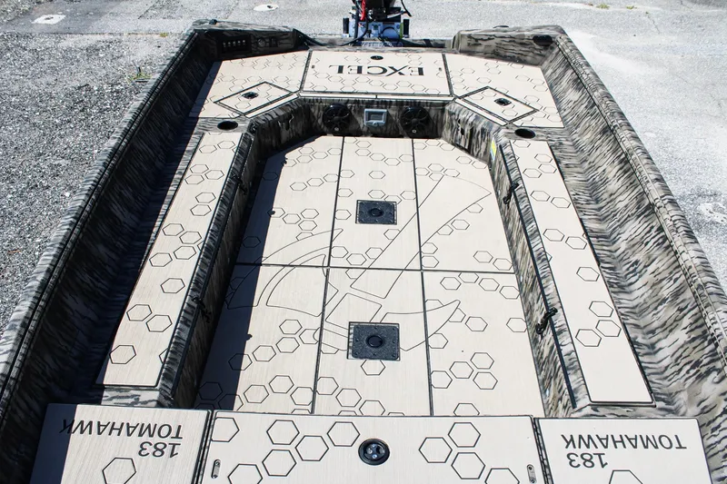 Slide: The Image of 2026 Excel Tomahawk 183 boat interior with hexagonal pattern design and storage compartments. - 10