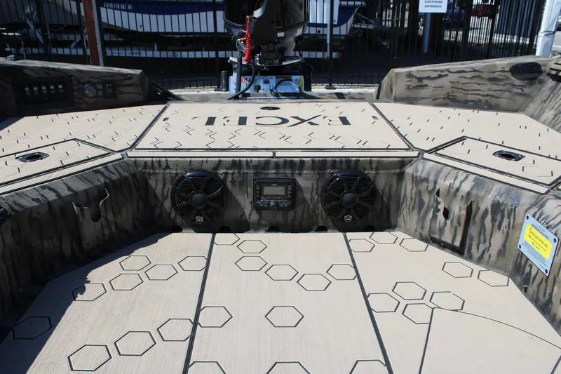 Slide: The Image of 2026 Excel Tomahawk 183 boat with camouflage design and LED lights, displayed outdoors. - 11
