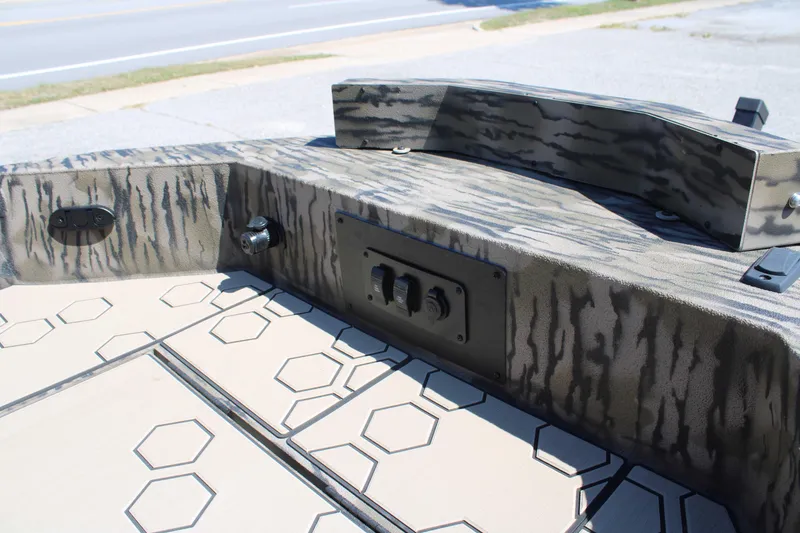 Slide: The Image of 2026 Excel Tomahawk 183 boat interior with hexagonal pattern and camouflage design. - 13