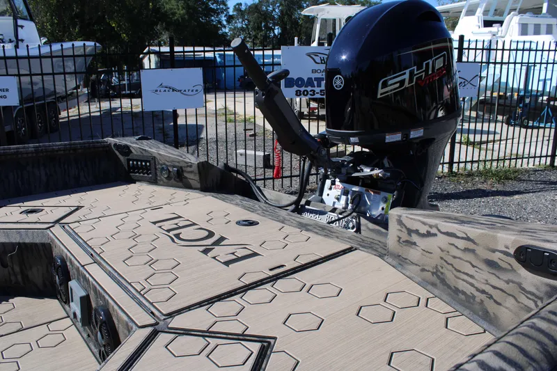 Slide: The Image of 2026 Excel Tomahawk 183 boat with Yamaha outboard motor, parked outdoors. - 15