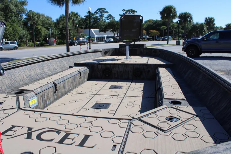 Slide: The Image of Open deck of 2026 Excel Tomahawk 183 boat with seating and storage compartments. - 16