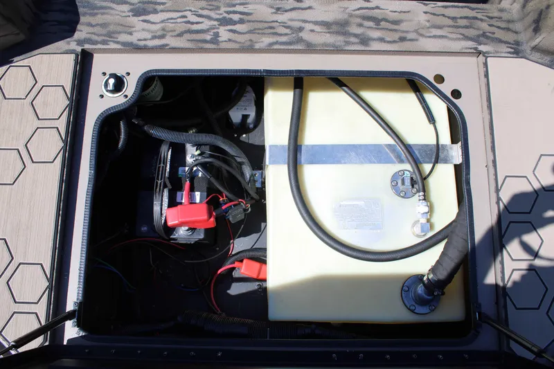 Slide: The Image of Open compartment of Excel Tomahawk 183 (2026) showing battery and fuel tank components. - 17