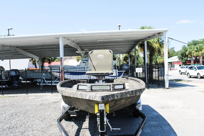 Slide: The Image of 2026 Excel Tomahawk 183 boat with 90 HP motor parked outdoors. - 2