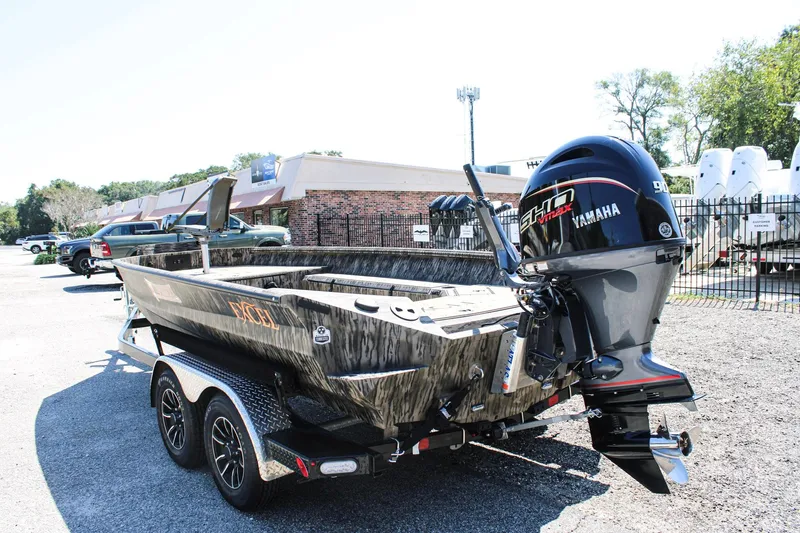 Slide: The Image of 2026 Excel Tomahawk 183 boat on trailer, parked outdoors under clear blue sky. - 5
