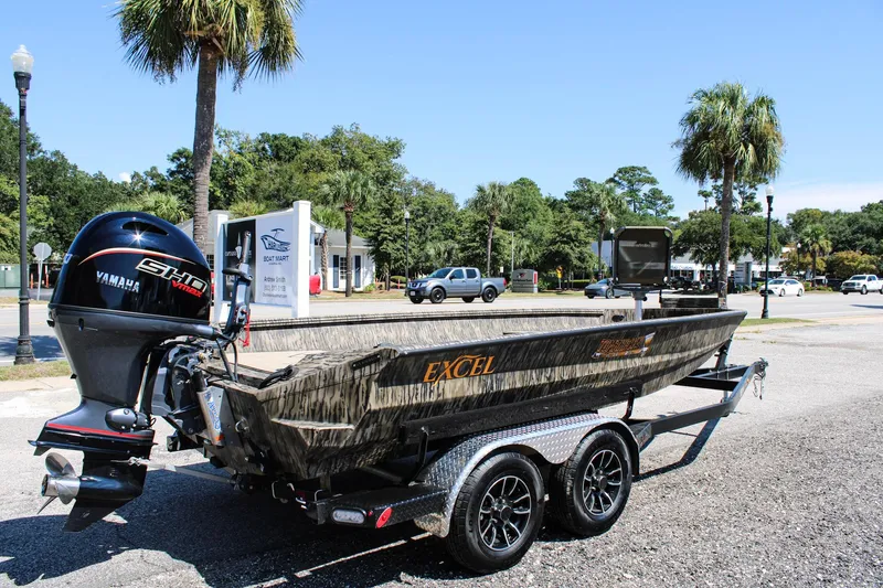Slide: The Image of 2026 Excel Tomahawk 183 boats on trailers at a dealership under a clear blue sky. - 6