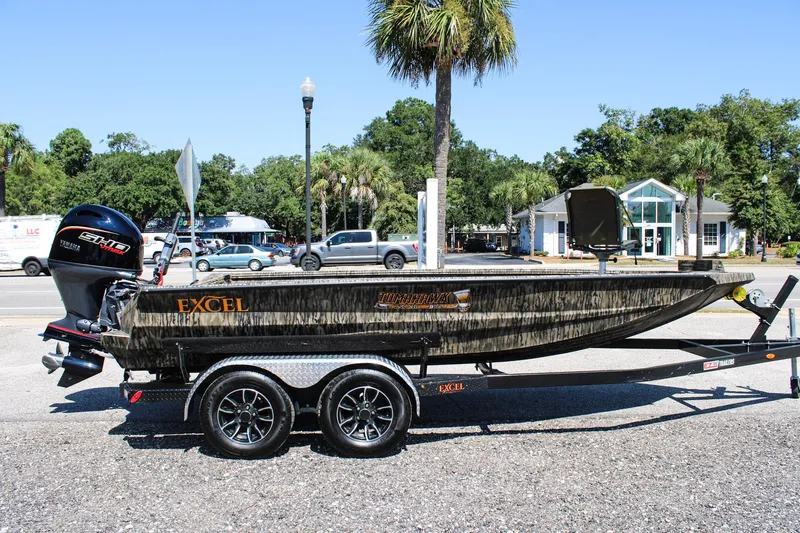 Slide: The Image of 2026 Excel Tomahawk 183 boat on trailer with Yamaha outboard motor, parked outdoors. - 7