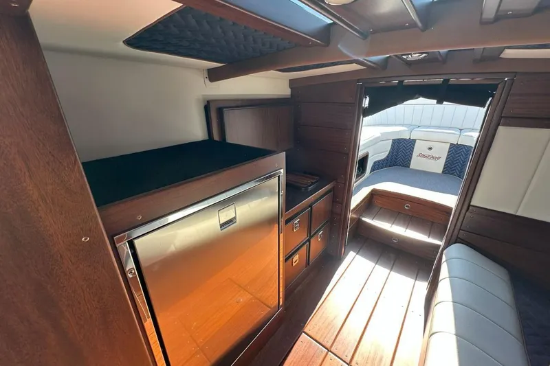 Slide: The Image of Interior of 2023 StanCraft 380 Rivelle boat with wood finish and seating area. - 19