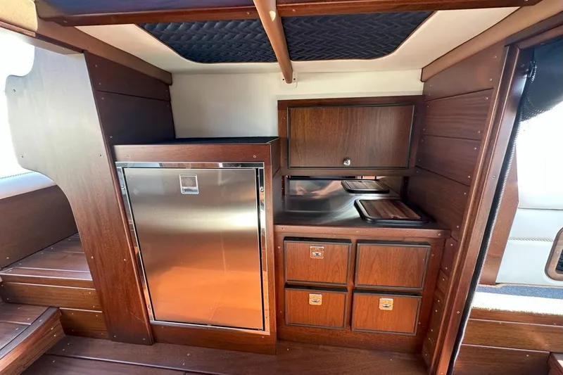 Slide: The Image of Luxurious 2023 StanCraft 380 Rivelle boat interior with wood cabinetry and stainless steel appliances. - 20