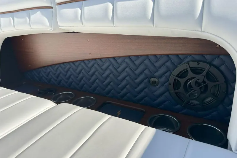 Slide: The Image of 2023 StanCraft 380 Rivelle interior with white leather seats, speaker, and cup holders. - 22