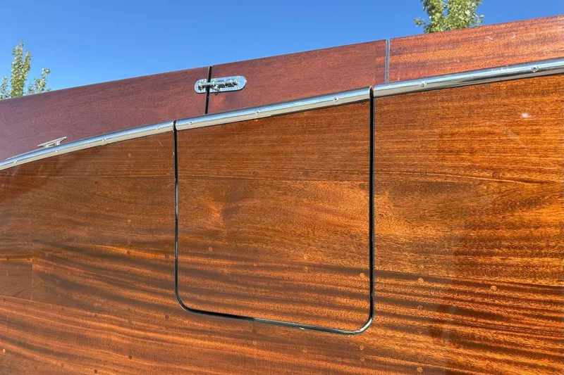 Slide: The Image of 2023 StanCraft 380 Rivelle boat, showcasing polished wooden exterior and sleek chrome detailing. - 5