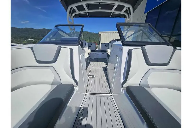 Slide: The Image of 2023 Yamaha Boats 252SD interior with sleek seating and modern design under clear blue sky. - 10