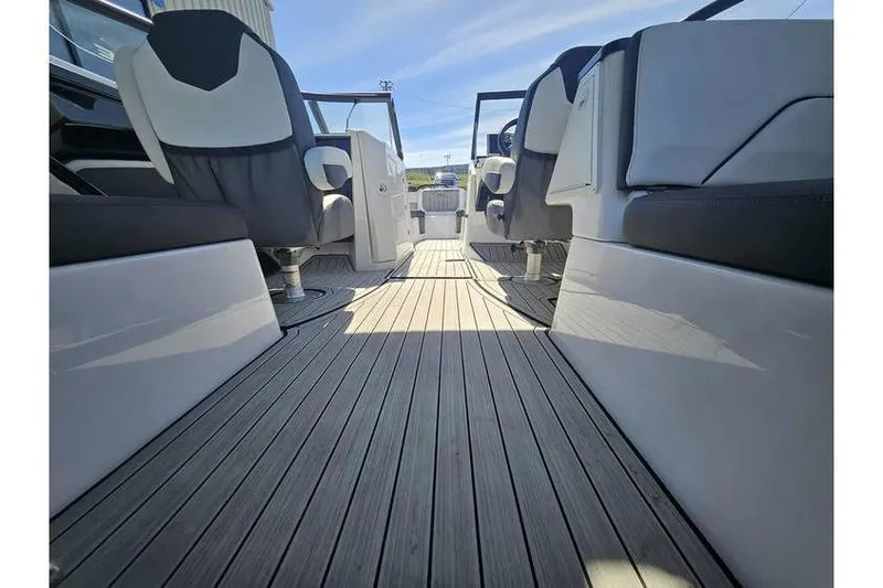 Slide: The Image of 2023 Yamaha Boats 252SD interior with sleek seating and wooden flooring. - 8