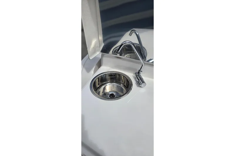Slide: The Image of Stainless steel sink and faucet on 2025 Ventura Daycruicer boat. - 10