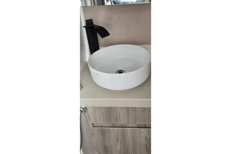 Slide: The Image of Modern bathroom sink with black faucet in 2025 Ventura Daycruicer. - 11