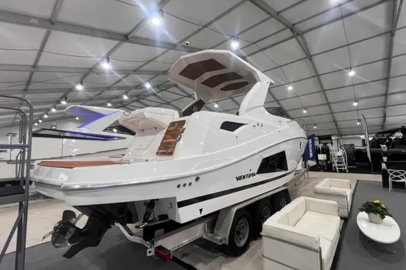 Slide: The Image of 2025 Ventura Daycruiser boat displayed indoors, showcasing sleek design and modern features. - 4